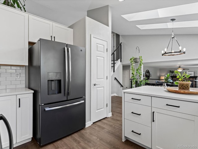 20789 E Princeton Pl, Aurora, CO 80013 - kitchen featuring stainless steel fridge, a skylight, white cabinetry, and dark wood-type flooring
