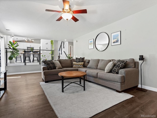 20789 E Princeton Pl, Aurora, CO 80013 - living room featuring baseboards, dark wood-type flooring, ceiling fan, and stairway