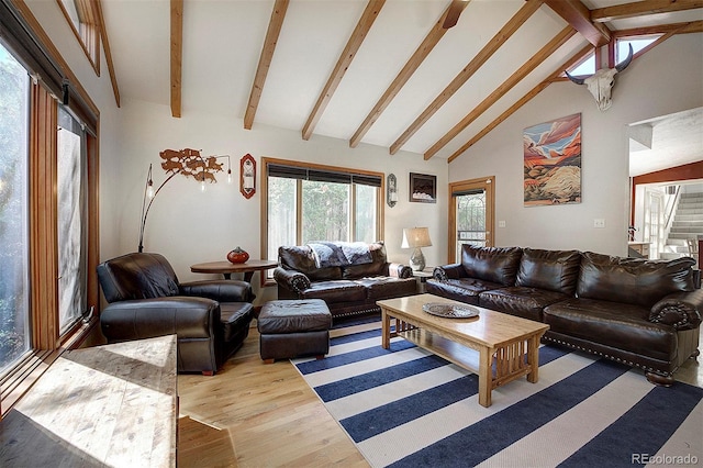 living room with beamed ceiling, light hardwood / wood-style flooring, and high vaulted ceiling