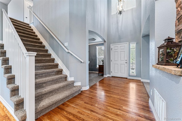 entryway featuring hardwood / wood-style floors and a high ceiling