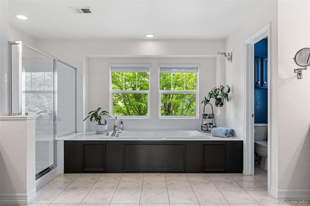 bathroom with tile patterned floors, independent shower and bath, and toilet