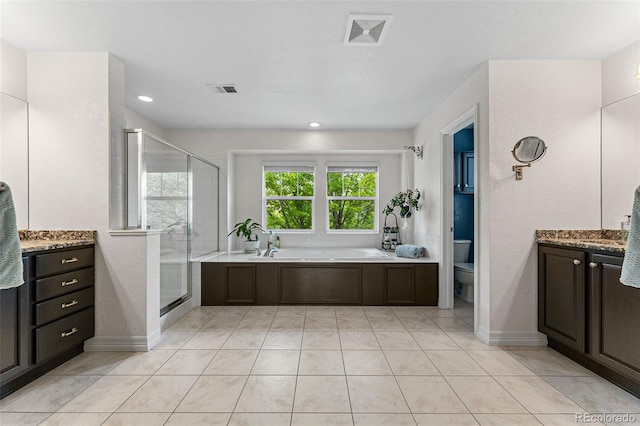 full bathroom featuring vanity, toilet, tile patterned flooring, and plus walk in shower