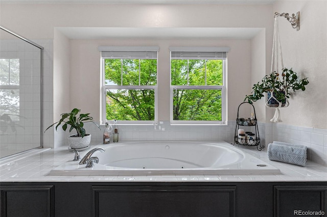 bathroom featuring a relaxing tiled tub