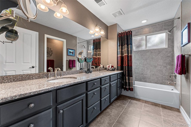 bathroom with shower / bath combination with curtain, vanity, tile patterned flooring, and a textured ceiling