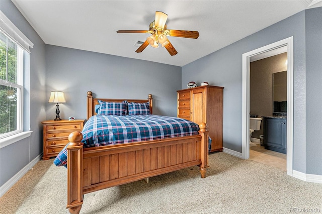 carpeted bedroom with connected bathroom and ceiling fan