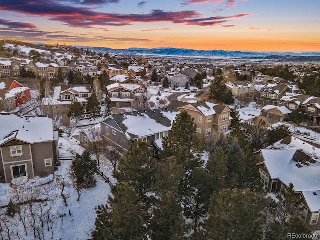 snowy aerial view featuring a mountain view