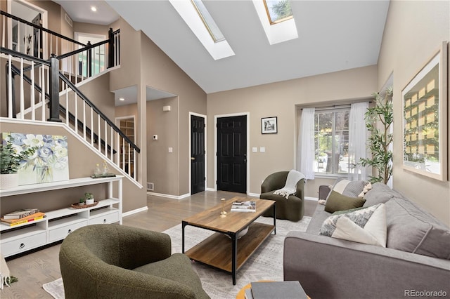 2043 Fendlebrush St, Highlands Ranch, CO 80129 - living area featuring stairway, high vaulted ceiling, a skylight, wood finished floors, and baseboards