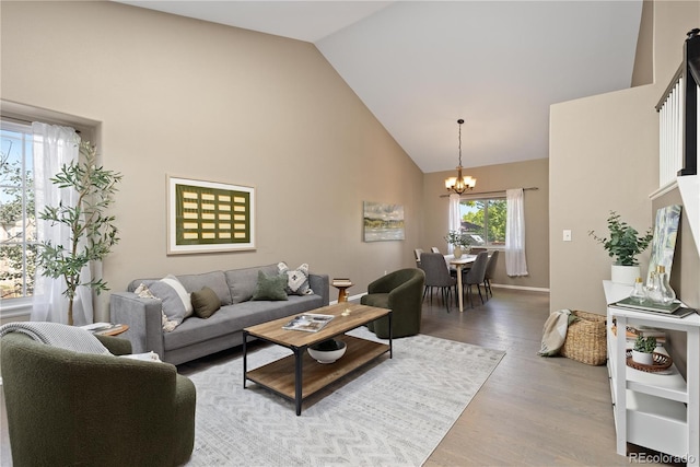 2043 Fendlebrush St, Highlands Ranch, CO 80129 - living area featuring a chandelier, high vaulted ceiling, and light wood-style flooring