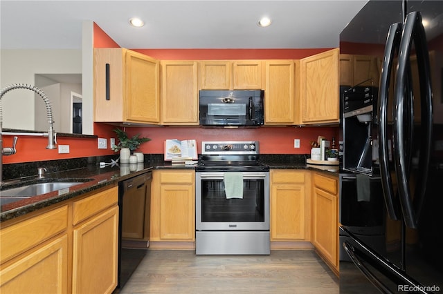 2043 Fendlebrush St, Highlands Ranch, CO 80129 - kitchen with black appliances, a sink, light wood finished floors, recessed lighting, and dark stone countertops