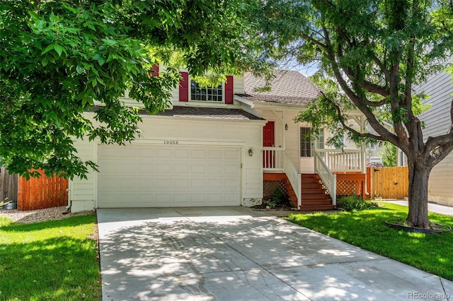 view of front of home featuring a front lawn and a garage