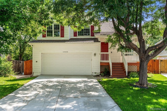 view of front of home with a front yard and a garage