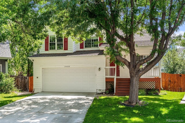 view of front of home with a front yard and a garage