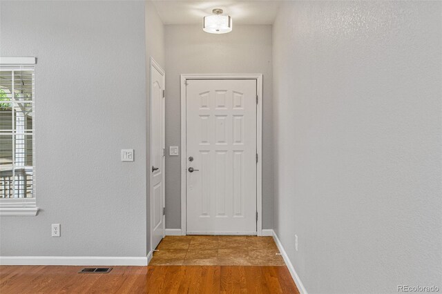 entryway with hardwood / wood-style flooring