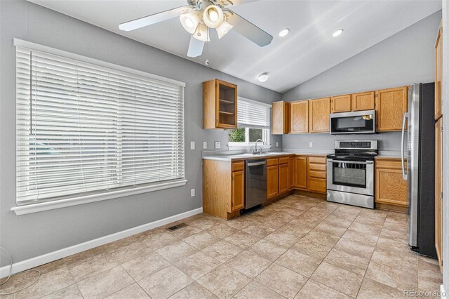 kitchen featuring light tile patterned floors, appliances with stainless steel finishes, ceiling fan, and lofted ceiling