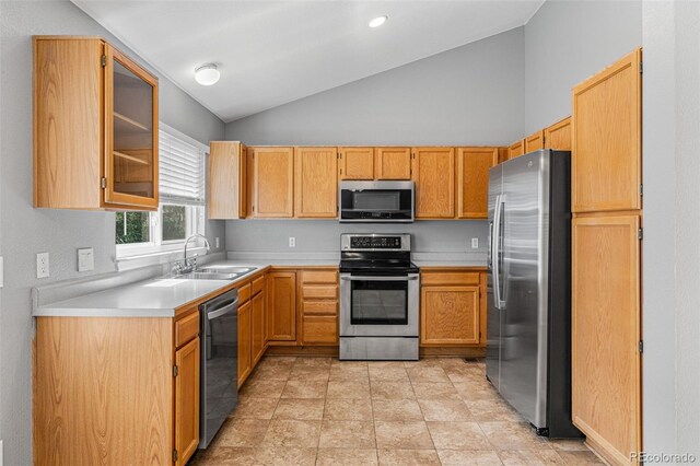 kitchen featuring light tile patterned floors, sink, stainless steel appliances, and high vaulted ceiling