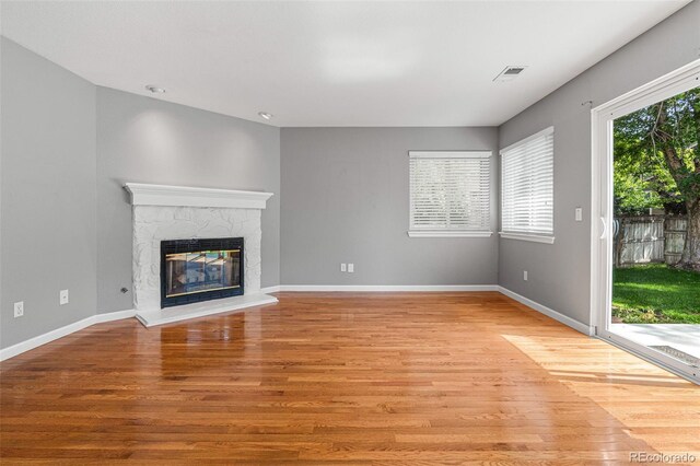 unfurnished living room with light hardwood / wood-style flooring