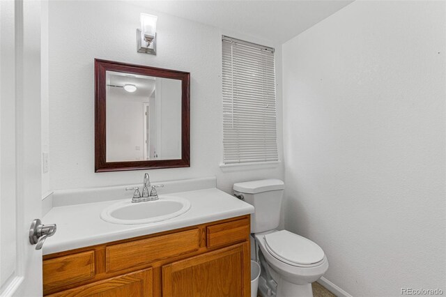 bathroom featuring toilet and vanity