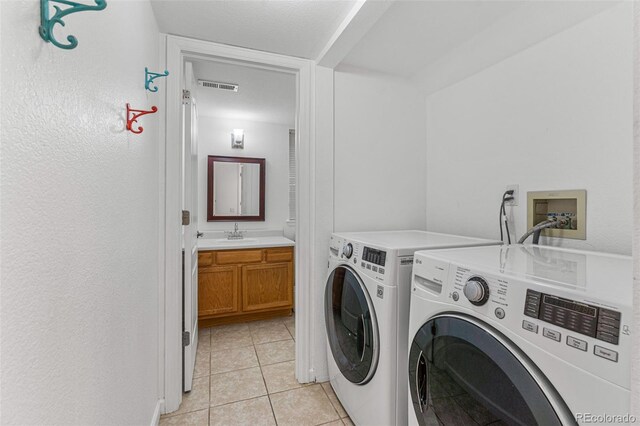 washroom with light tile patterned floors and separate washer and dryer