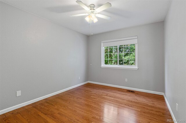 empty room with light hardwood / wood-style flooring and ceiling fan