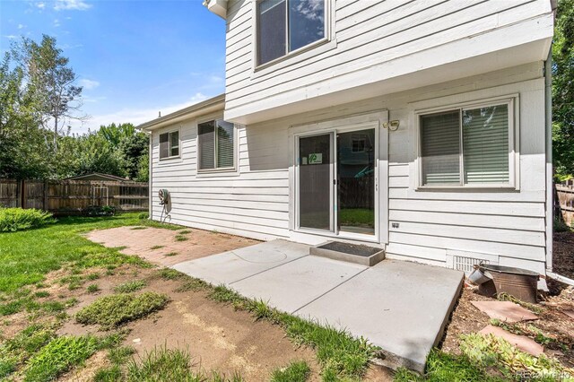 rear view of property with a yard and a patio