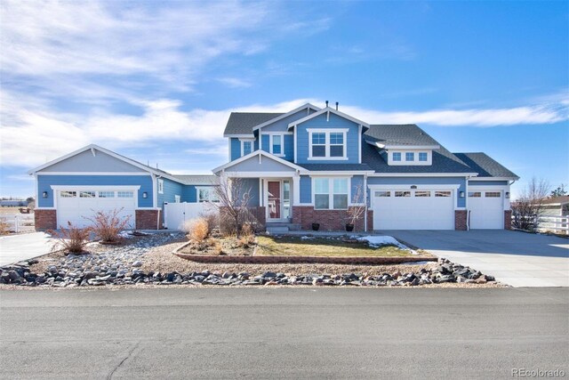 craftsman-style home with brick siding, concrete driveway, a garage, and fence