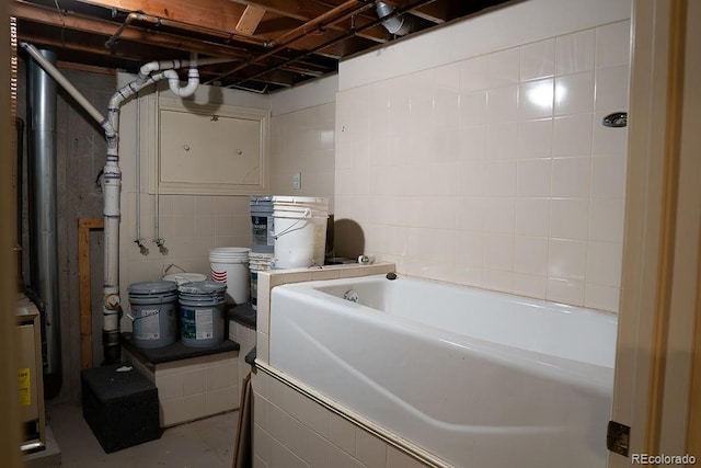 unfinished below grade area featuring tile walls