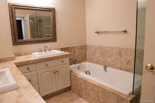 full bathroom with vanity, a shower stall, and a bath