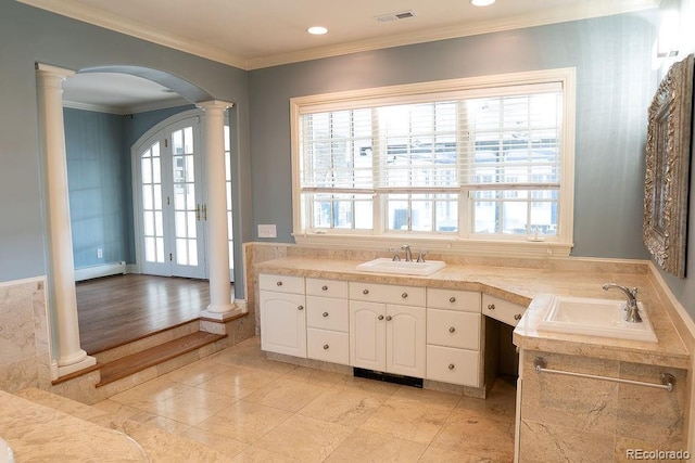 bathroom featuring ornate columns, baseboard heating, ornamental molding, vanity, and recessed lighting