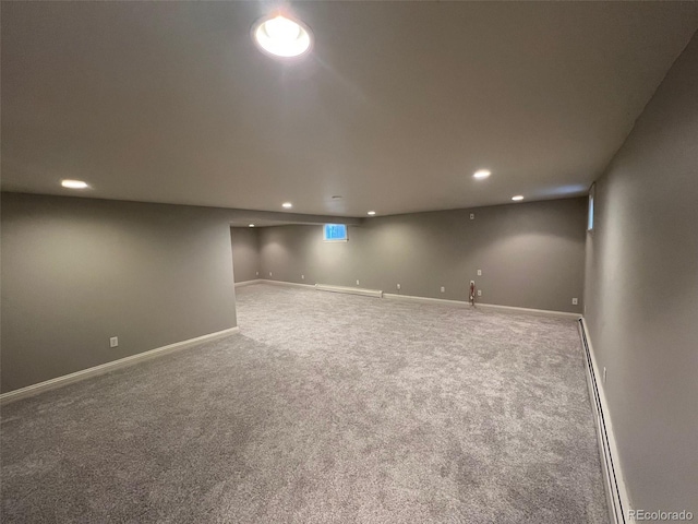finished below grade area featuring recessed lighting, carpet, a baseboard heating unit, and baseboards