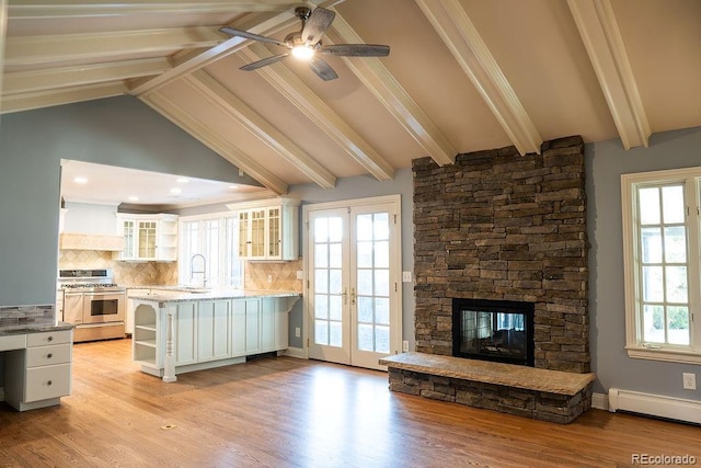 kitchen with double oven range, french doors, open shelves, a baseboard radiator, and white cabinetry