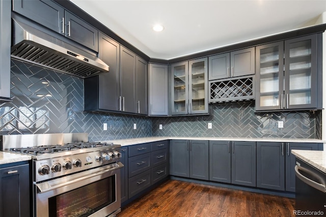 kitchen featuring light stone countertops, appliances with stainless steel finishes, and dark hardwood / wood-style flooring