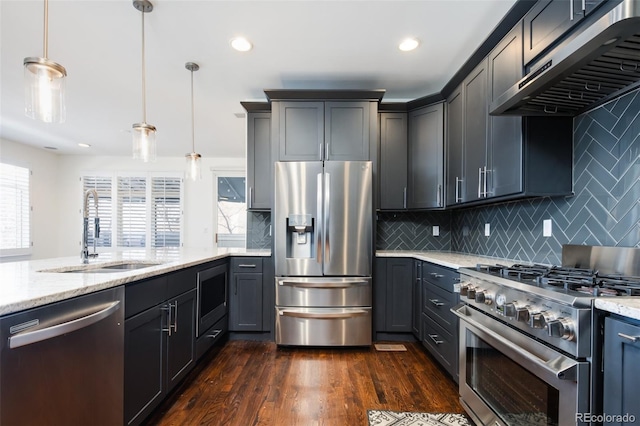 kitchen featuring appliances with stainless steel finishes, backsplash, dark hardwood / wood-style flooring, exhaust hood, and pendant lighting