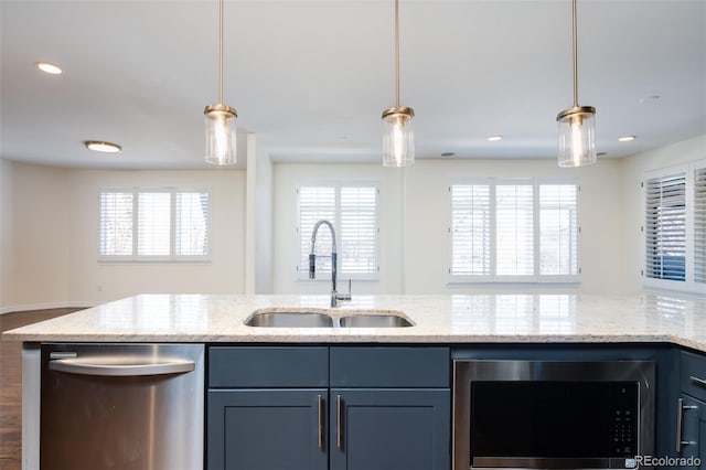 kitchen with light stone countertops, a wealth of natural light, sink, and stainless steel appliances