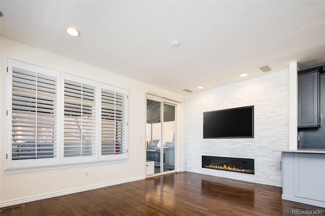 unfurnished living room with dark hardwood / wood-style floors and a fireplace