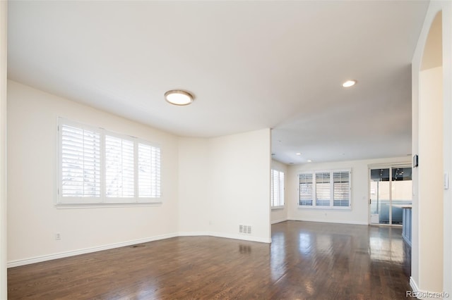 unfurnished living room featuring dark hardwood / wood-style floors