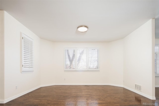 spare room with dark hardwood / wood-style flooring