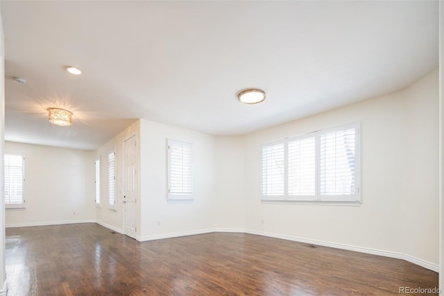 spare room with dark wood-type flooring