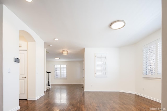 unfurnished room with dark hardwood / wood-style flooring