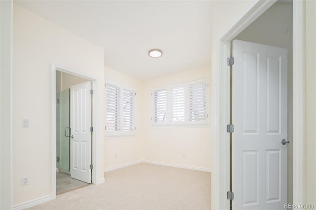 unfurnished bedroom featuring light colored carpet