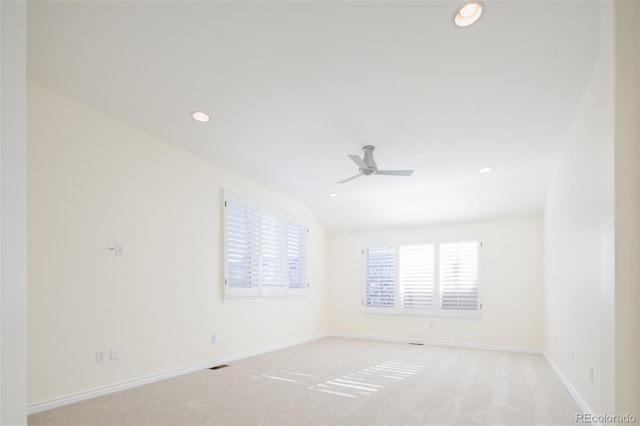 unfurnished room with ceiling fan, light colored carpet, and lofted ceiling