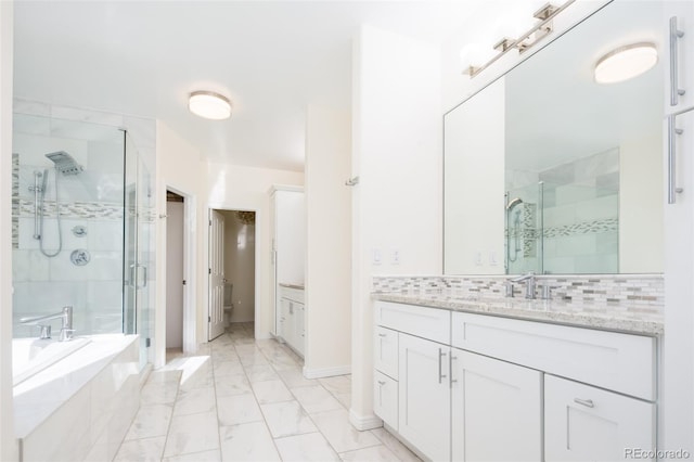 bathroom with backsplash, vanity, and plus walk in shower