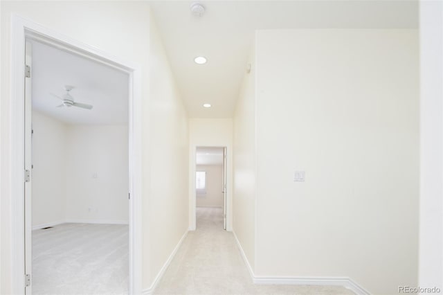 hallway featuring light colored carpet