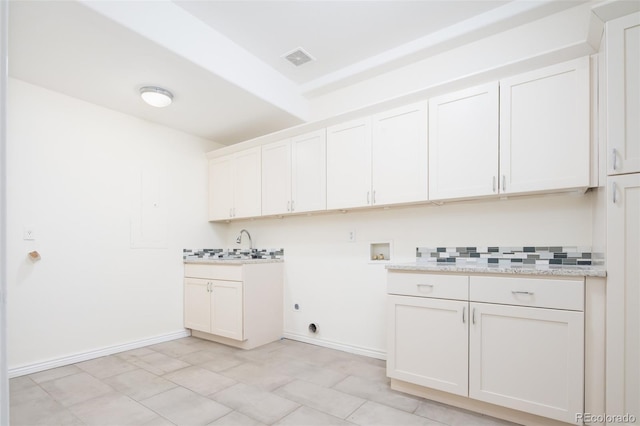 laundry room with cabinets, washer hookup, hookup for an electric dryer, and sink