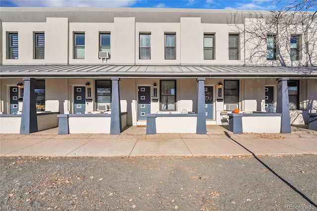 view of front of home featuring a porch and cooling unit