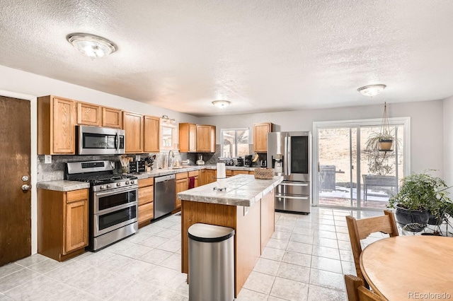 kitchen featuring a center island, light tile patterned floors, stainless steel appliances, and tasteful backsplash