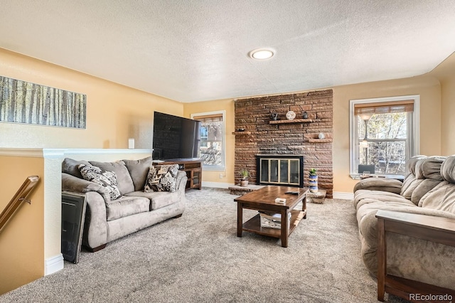 carpeted living room featuring a fireplace and a textured ceiling