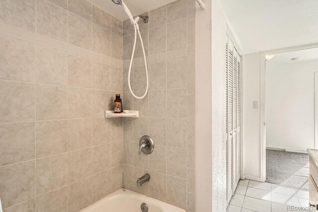 bathroom with tile patterned flooring and tiled shower / bath combo