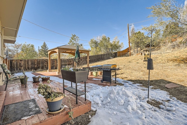 snow covered patio featuring a gazebo