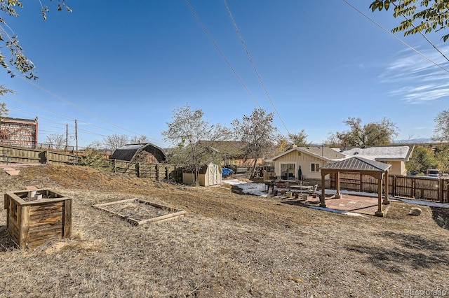 view of yard with a gazebo, a patio area, and a storage unit