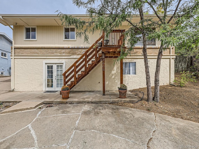 back of property with a patio area and french doors